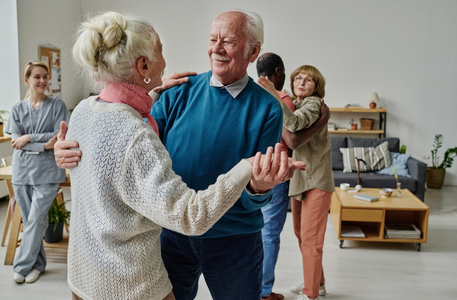 A senior couple dances together at a senior living community.